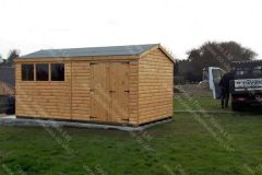 16x10Log-Lap-Apex-Shed-with-barn-door-and-standard-windows-treated-autum-gold-